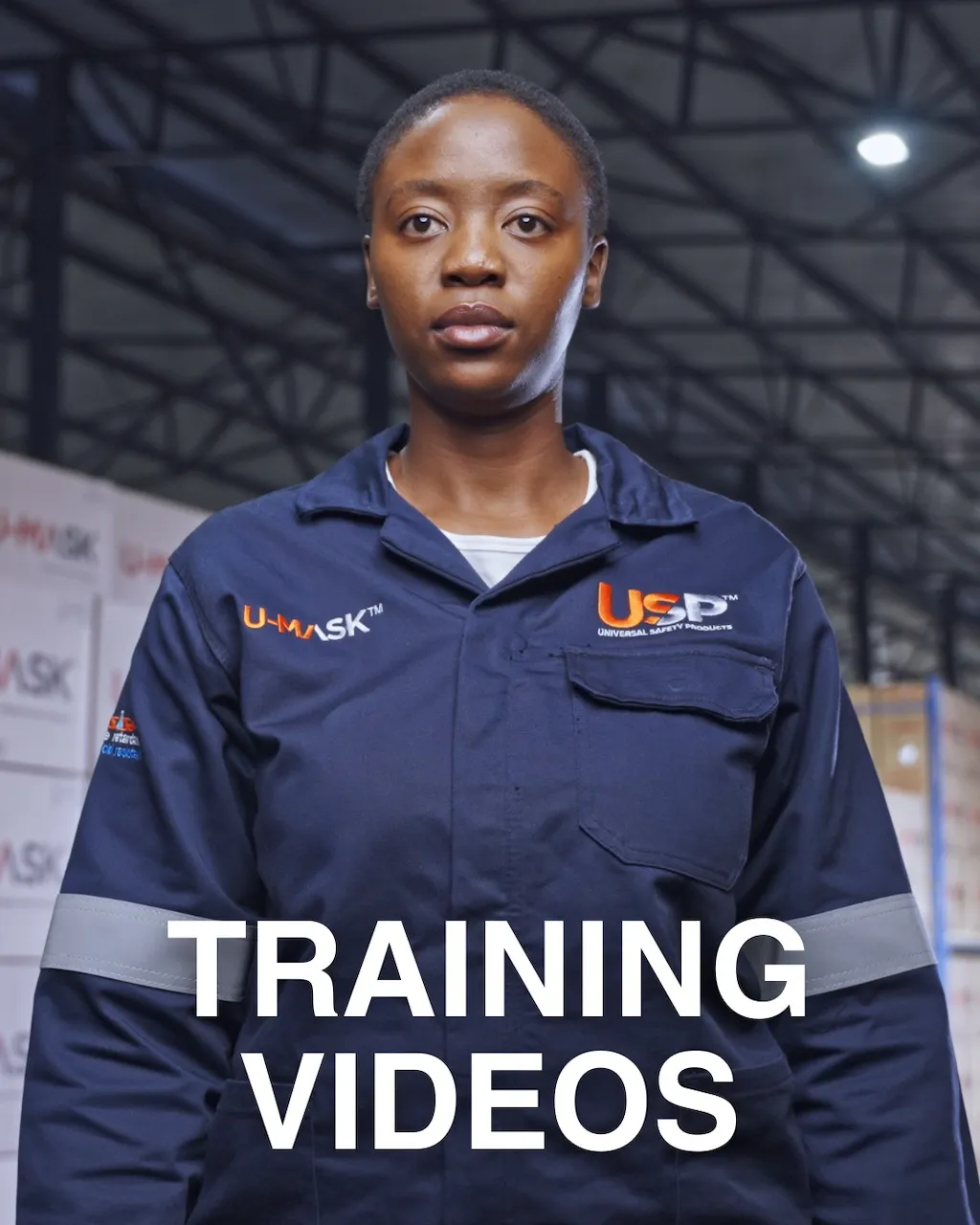 Medium shot of a woman in overalls inside a well lit factory. art of the Training Video Production services provided by pretoria based production company The Chalk Factory.